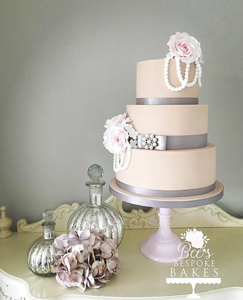 An elegant three tier latte wedding cake adorned with pearls and delicate pink sugar roses - Bee's Bespoke Bakes