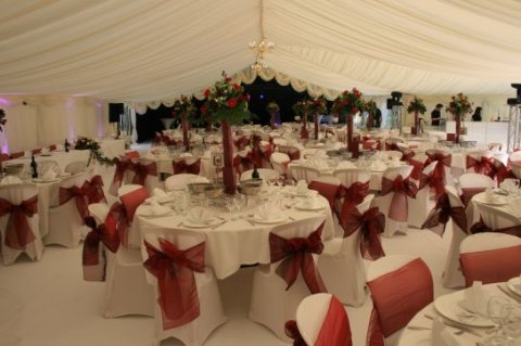 Red themed wedding with chair covers and bows - Creslow Events