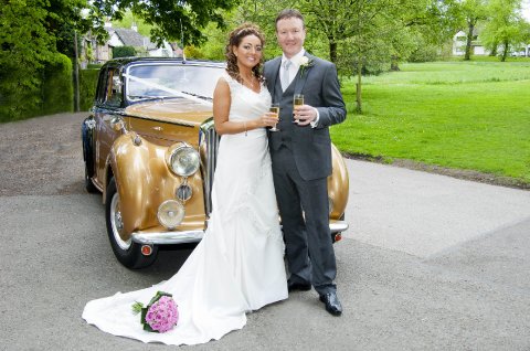 Bride & groom by wedding car - Blue Ribbon Photos