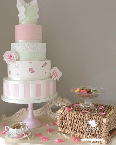 Vintage inspired four tier wedding cake with delicate hand painted roses, candy stripes, cake lace, sugar roses and a beautiful sugar bow - Bee's Bespoke Bakes