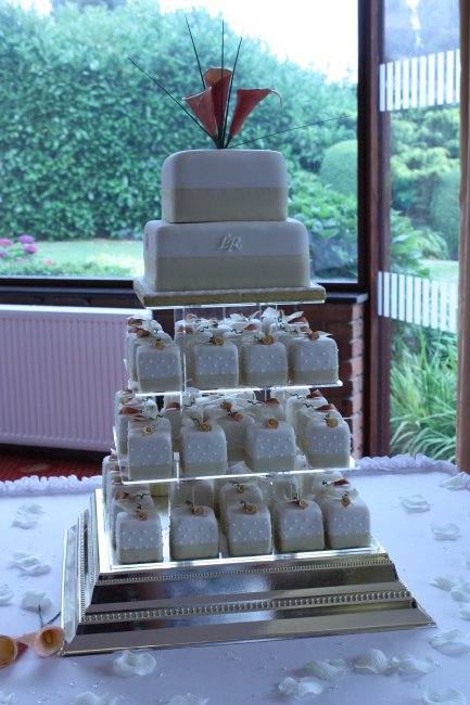 Two tiered wedding cake with Individually iced cakes decorated with sugar calla lilies - The Cake Studio Worcester