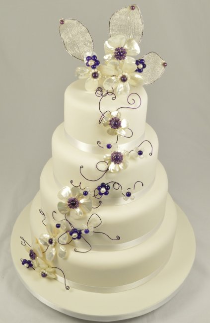 Four tier wedding cake with purple detailing - Cakes of Good Taste