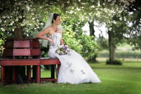 Bride enjoying the sunshine in the Brooksby Hall grounds - Brooksby Hall