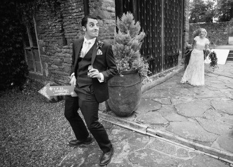 Groom demonstrating his manliness with bride laughing at How Caple Court - Ketch 22 photography