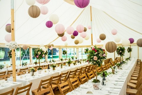 Interior with trestle tables and hanging lantern canopy at Newby Hall - Will's Marquees