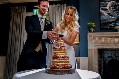 Michelle and Gary cutting the cake in the Signet Room - The Swan Hotel