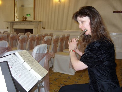 Playing live during the wedding ceremony on flute - Carillon Flute & Guitar Duo