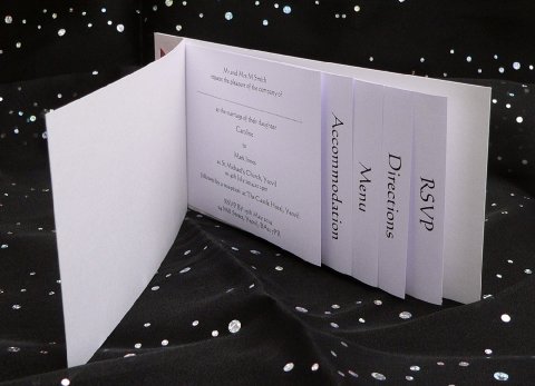 This very practical cheque book style design is useful if you have extra information which you need to provide for your guests, incorporating a satin ribbon holding the pages together. - Silver Dove Wedding Stationery