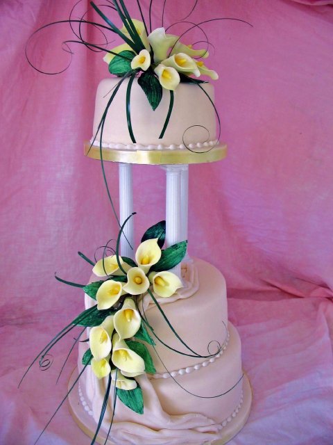 Half stacked Wedding cake with swags and yellow suhar cala lillies - Elizabeth Ann's Confectionery