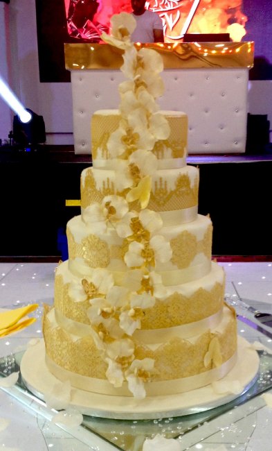 beautiful hand made sugar flowers , dusted in gold, with edible gold cake lace - Maries Couture Cakes