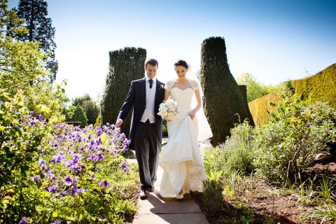 Bride & Groom strolling through the gardens - Berkeley Castle 