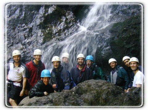 Group photo under the waterfall - Bach Ventures Ltd