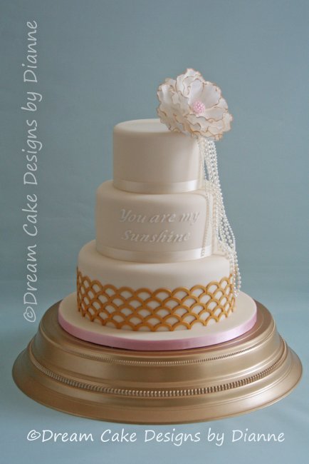 3 Tier White & Gold Wedding Cake with large fantasy flower and pearls. Inspired by 'The Great Gatsby and You are my Sunshine' - Dream Cake Designs (Dianne Stanley)