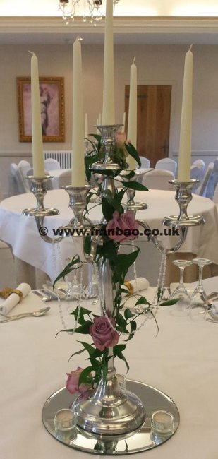 our candelabras available for hire dressed with floral garland - Forget Me Not Blooms Balloons Occasions