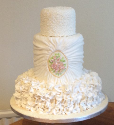 Three tier with double barrel middle tier, ruffles and ruched effect - Cakes Unlimited of Yorkshire