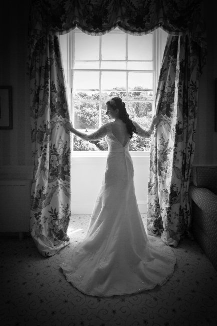 Bride framed by window - PB Photography