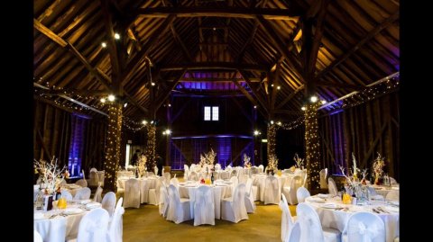 Barn Fairy lighting, chair covers and manzanita tree centerpieces - Balloon and party Kingdom