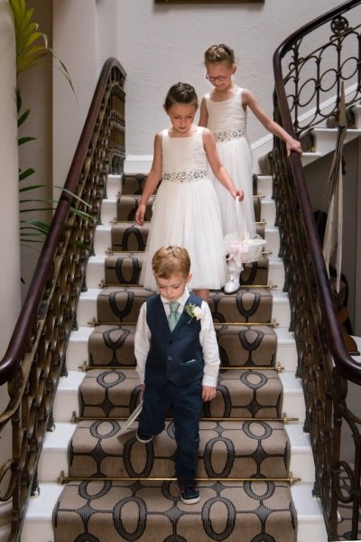 Flower girls and ring bearer come down stairs at Storrs Hall wedding - Simon Hughes Photography