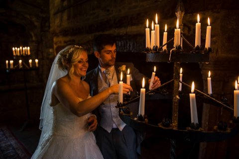 bride and groom light candle - GE Photography