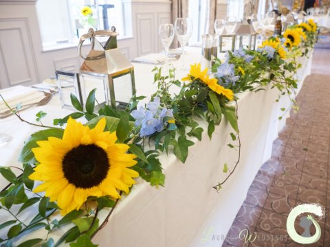 Sunflower and delphinium top table garland - Laurel Weddings