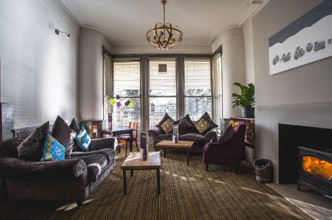 Lounge area in our main bar in front of the log fire - Herriots Hotel with Rhubarb Restaurant 