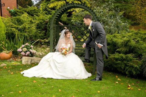 Bride and groom relaxing in the garden - Chris Mimmack Photography