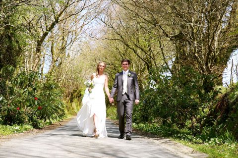 Newly weds walking down the magical tree lined lane - Ta Mill Weddings