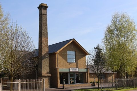 The shop beneath the old ironworks chimney - Chimney Formal Menswear