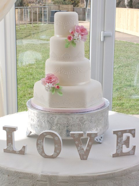 Beautiful four tier wedding cake with handmade sugar flowers and sugar lace - Rebecca Gilmore Wedding Cakes