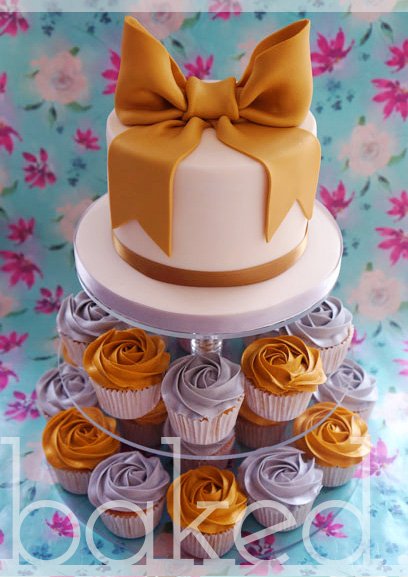 metalic bow cake with matching cupcakes - Baked Cupcakery