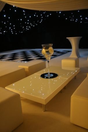 Reception furniture in the marquee and the starlight effect over the dance floor - Creslow Events