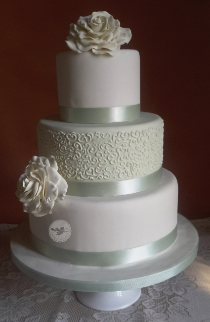 Large sugar roses and delicate hand piping create a beautiful cake. - Sophisticakes 