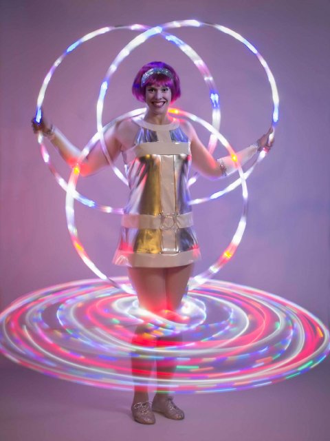 Kat Collett with multiple glow hoops - Kat Collett: Scintillating Circus Entertainment