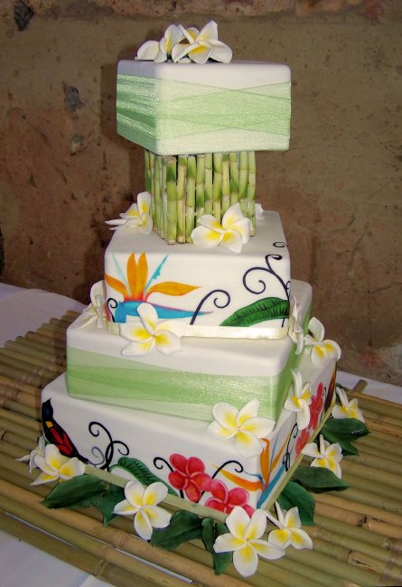 "Tropical Twist" wedding cake with bamboo separator and sugar Frangipani flowers. - The Incredible Cake Company