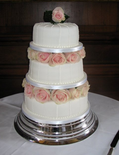 Wedding cake with fresh pink roses between tiers - Elizabeth Ann's Confectionery