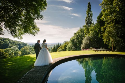 Bride and groom waliking through gardens at Kiftsgate in Gloucestershire - Ketch 22 photography