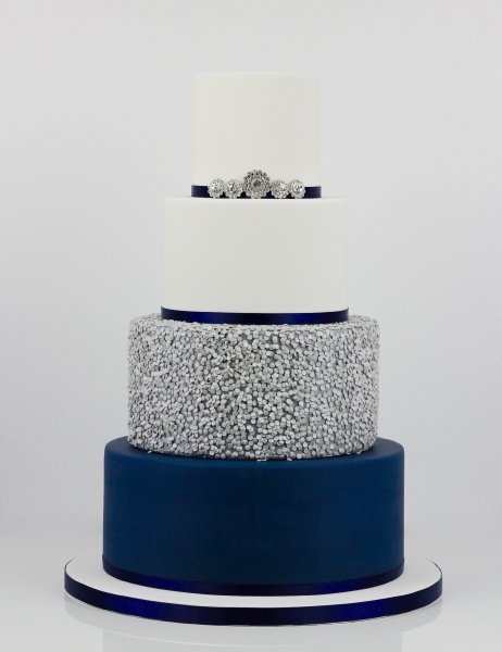 Navy tier with silver edible sequins and diamante brooches - Fay's cakes