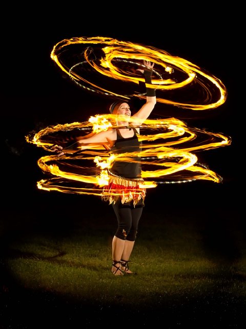 Kat Collett with three fire hoops - Kat Collett: Scintillating Circus Entertainment