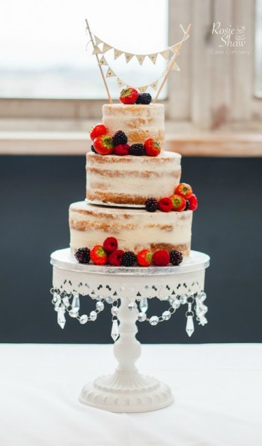 Vintage naked cake finished off with bunting and seasonal berries - Rosie Shaw Cake Company