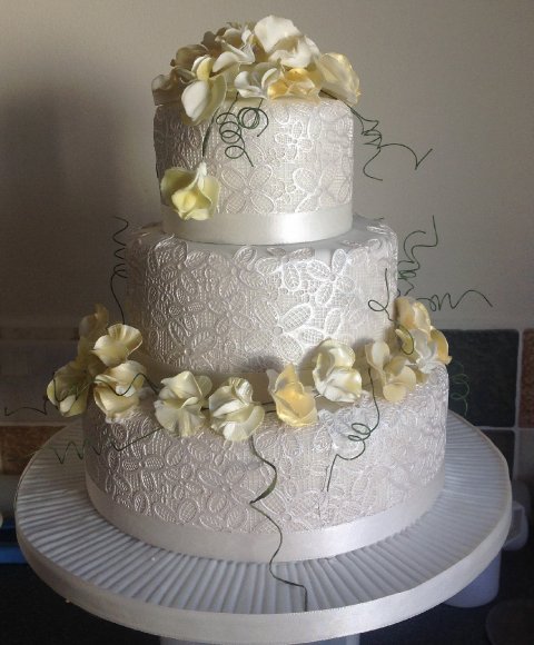 Three tier with edible lace and sugar sweet peas - Cakes Unlimited of Yorkshire