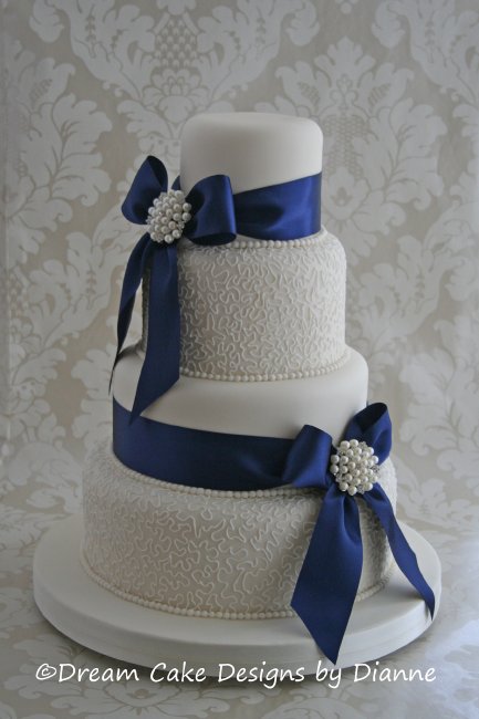 4 Tier White Wedding Cake with satin bows diamante and pearl brooches and filigree piped detail. - Dream Cake Designs (Dianne Stanley)