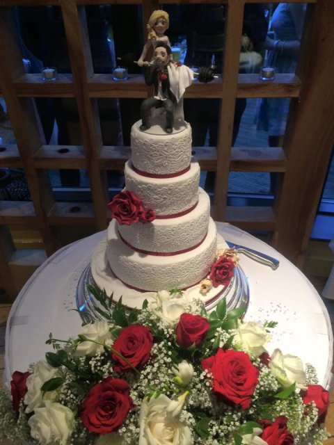 Four tier with edible lace and roses - weightlifting topper - Cakes Unlimited of Yorkshire