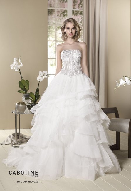 Sexy touch wedding dress. Semi-sheer bodice covered in a beaded overlay and ruffled silked tulle skirt finished off nylon. - GN DESIGN GROUP