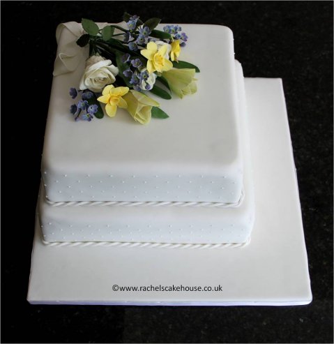 Two tiers of traditional fruit cake, topped with a sugar flower bouquet. - Rachel's Cake House