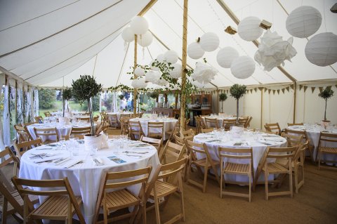 Interior of 18m x 9m Canvas pole tent with round tables and wooden folding chairsl nal t - FOUR SEASONS MARQUEES LIMITED 