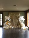 gold sequin backdrop white ostrich feather centrepieces.jpg